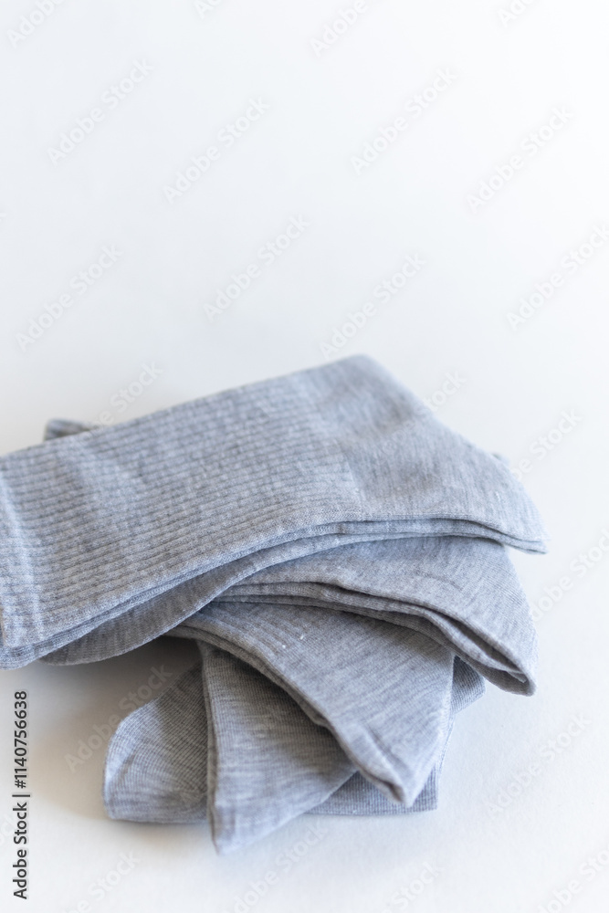 gray socks with a stack of fan coloring. close-up on a white background gray socks with a stack of fan coloring. close-up on a white background