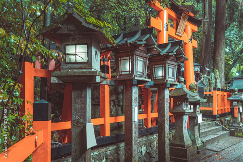 Traditional japanese stone toro lanterns at Fushimi Inari Taisha in Kyoto. (English translation of the japanese text: religious blessings) photo