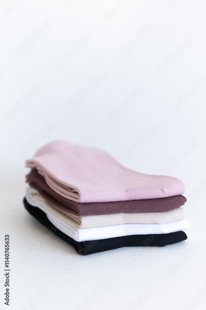 colored socks in a stack. close-up on a white background colored socks in a stack. close-up on a white background