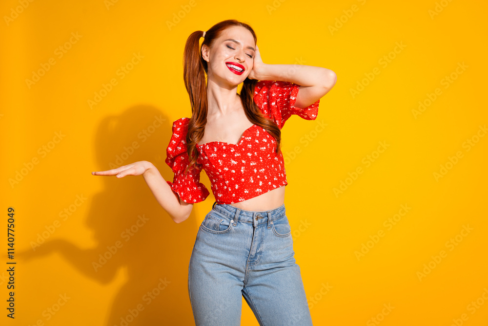 Photo portrait of young red hair funky positive girl wearing blouse and jeans professional dj playing music isolated on yellow color background Photo portrait of young red hair funky positive girl wearing blouse and jeans professional dj playing music isolated on yellow color background
