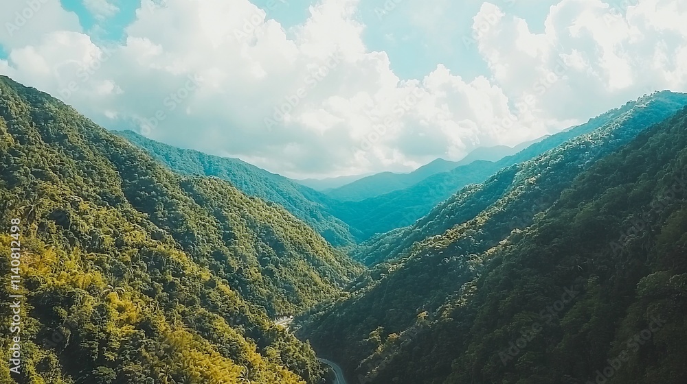 Naklejka premium A serene mountain landscape with lush greenery and winding roads.