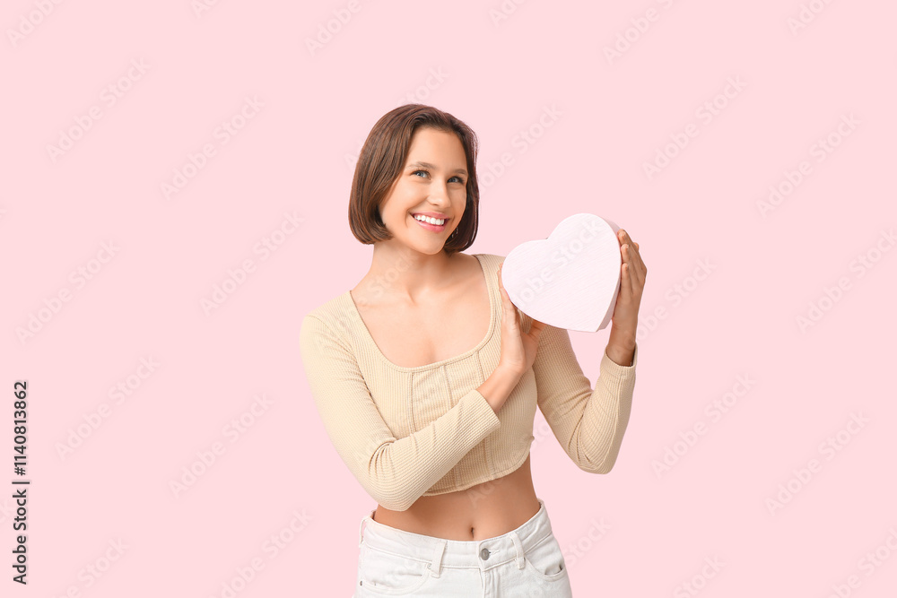 Beautiful young woman with gift box on pink background. Valentine's Day celebration Beautiful young woman with gift box on pink background. Valentine's Day celebration