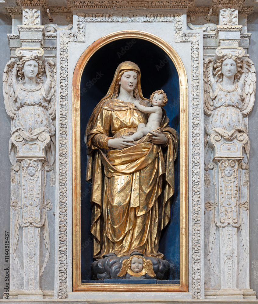 Obraz premium PAVIA, ITALY - SEPTEMBER 9, 2024: The carved polychrome statue of Madonna in the church Chiesa di San Luca from beginn of 16. cent.