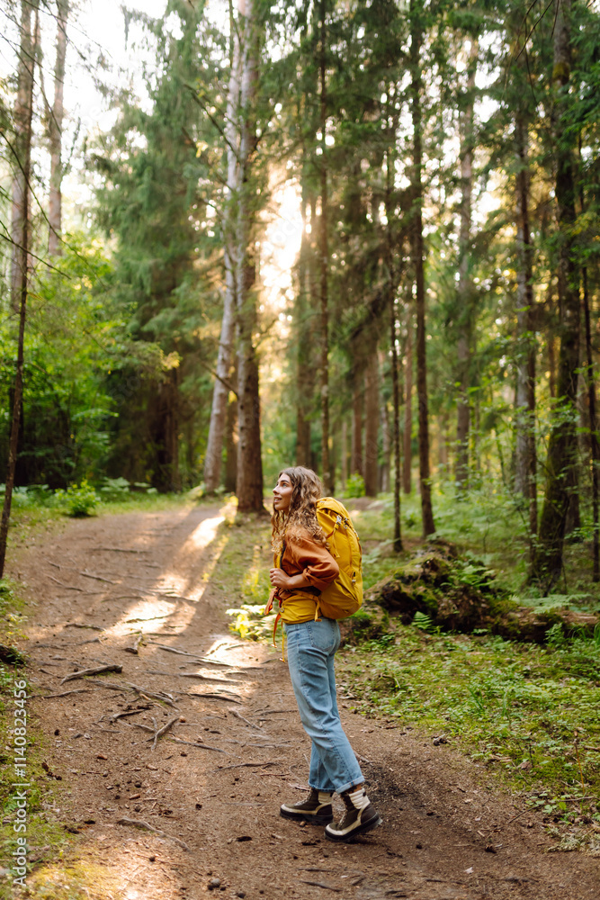 Happy young woman tourist enjoying in the beautiful forest. Hike and joy in nature. Happy young woman tourist enjoying in the beautiful forest. Hike and joy in nature.