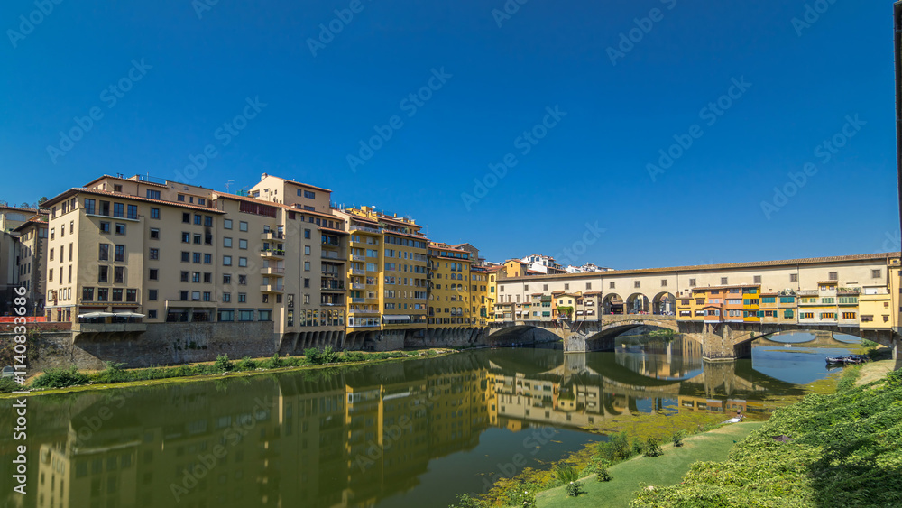 Obraz premium The Ponte Vecchio on a sunny day timelapse hyperlapse, a medieval stone segmental arch bridge over the Arno River, in Florence, Italy