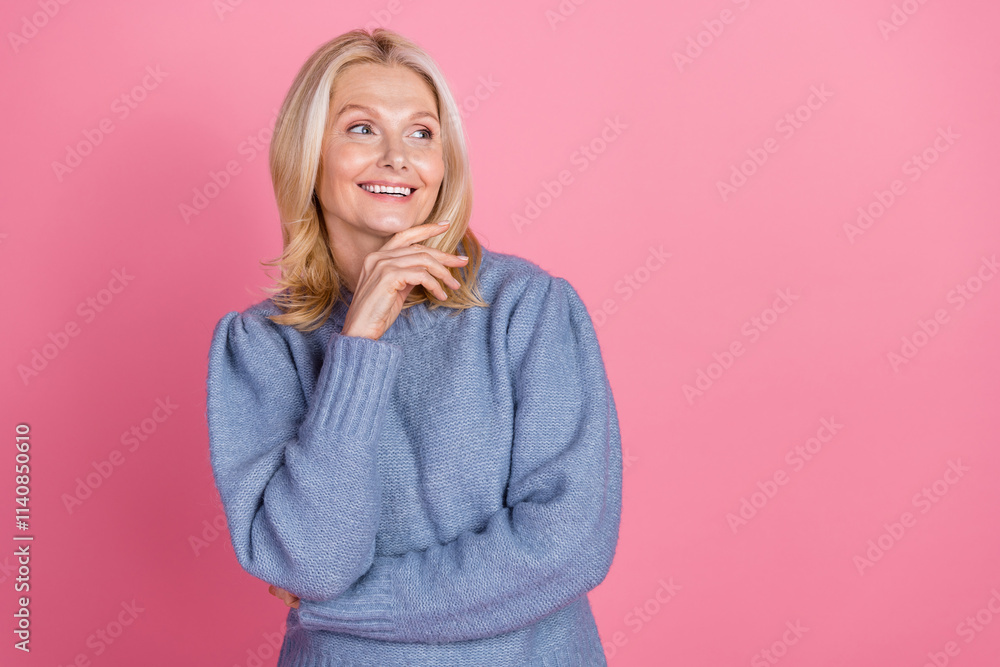 Photo portrait of pretty retired female look thinking empty space wear trendy blue knitted outfit isolated on pink color background Photo portrait of pretty retired female look thinking empty space wear trendy blue knitted outfit isolated on pink color background