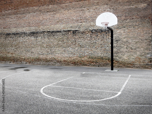 Basketball Hoop Urban Setting Downtown in the City Old Brick Wall photo