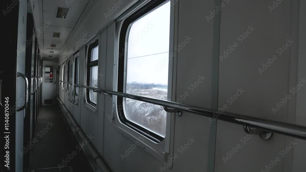 Passenger train car from the inside. Winter landscapes rush past the windows. Winter train travel. Passenger train car from the inside. Winter landscapes rush past the windows. Winter train travel.