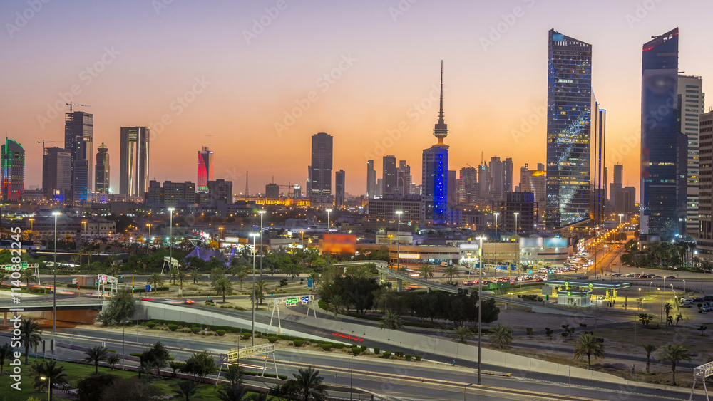 Fototapeta premium Skyline with Skyscrapers day to night timelapse in Kuwait City downtown illuminated at dusk. Kuwait City, Middle East