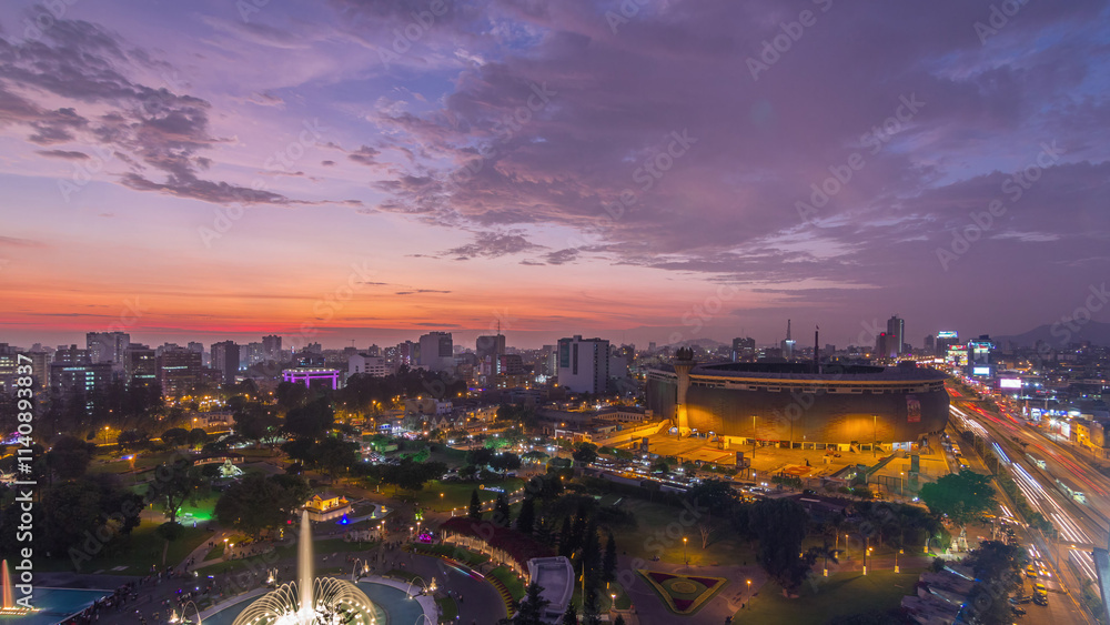 Fototapeta premium Aerial view of the National stadium in the Peruvian capital Lima with Park of the Reservey day to night timelapse