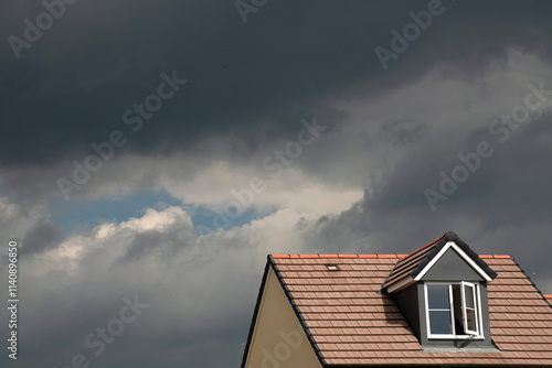 Nimbostratus clouds threatening rain over modern housing.