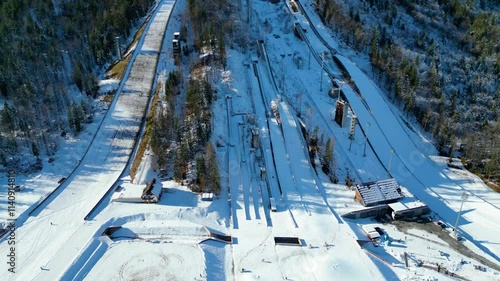 Planica Nordic Centre, nestled in the breathtaking Julian Alps of Slovenia, is a world-renowned destination for ski jumping and winter sports captured from a drone photo