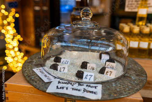 Tablou pe pânză London, UK – December 3, 2024, Truffle mushrooms under a glass dome at Borough Market