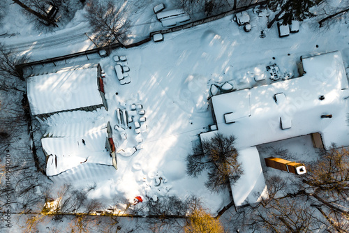 Unused industrial area with warehouses covered with snow, aerial view photo