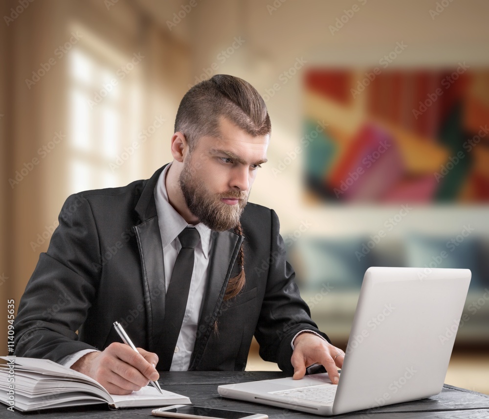 Happy handsome entrepreneur man work on laptop at office Happy handsome entrepreneur man work on laptop at office