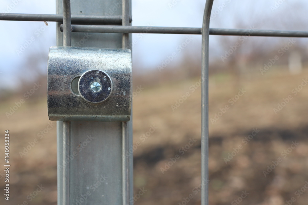 This is a CloseUp of a Metal Fence Connector Set Against a Nature Background with Beauty This is a CloseUp of a Metal Fence Connector Set Against a Nature Background with Beauty