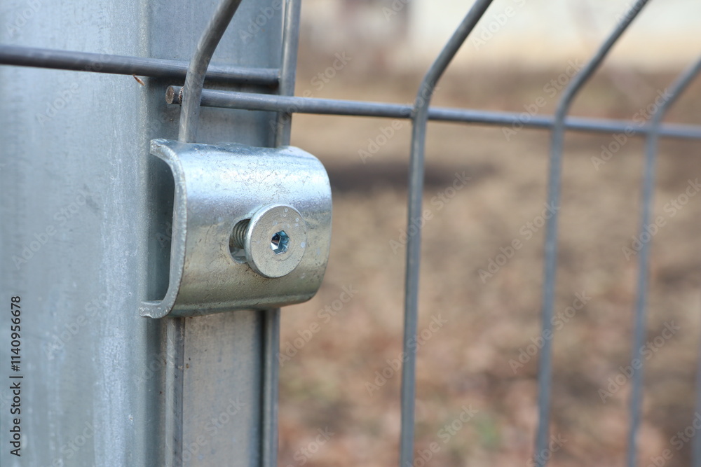 Detailed closeup image showcasing a Metal Fence Connector along with its Lock Mechanism Detailed closeup image showcasing a Metal Fence Connector along with its Lock Mechanism