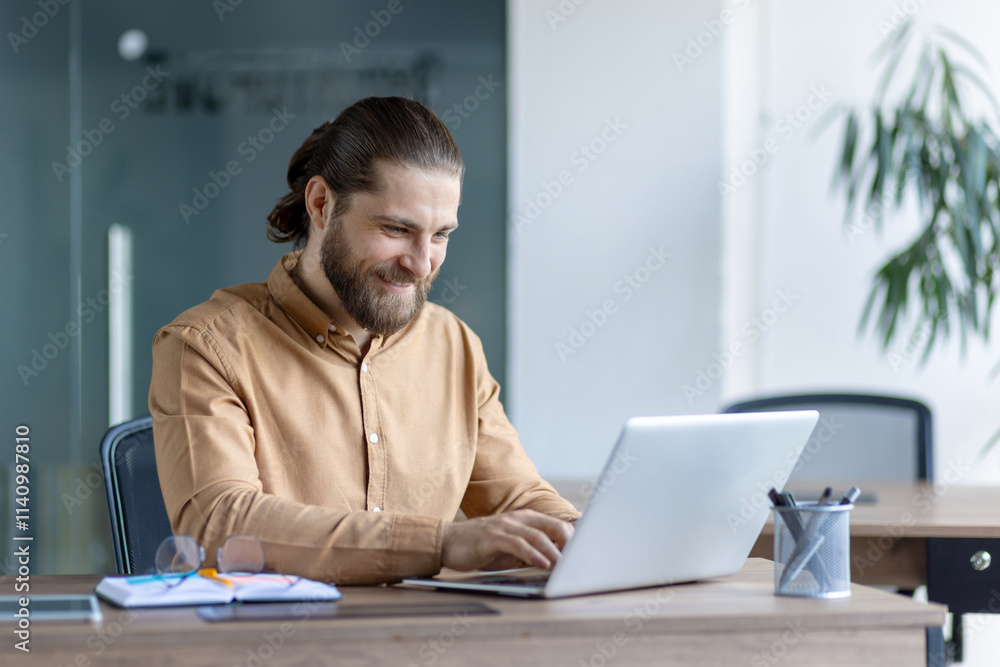 A businessperson works happily at a computer in an office setting, demonstrating productivity and focus. A businessperson works happily at a computer in an office setting, demonstrating productivity and focus.