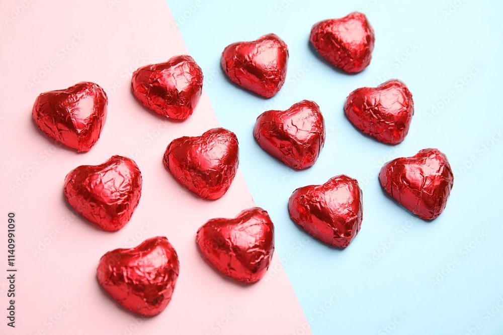 Heart shaped chocolate candies on color background. Valentine's day treat Heart shaped chocolate candies on color background. Valentine's day treat