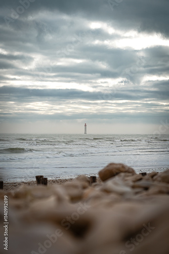 Chauveau lighthouse, isle of Re, at sunrise on a wavy sea. photo