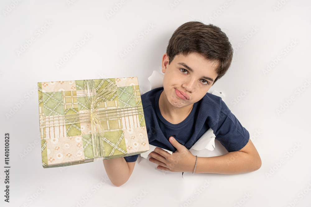 Brazilian 11 year old child with their body through a white cardboard and a disappointed expression. Brazilian 11 year old child with their body through a white cardboard and a disappointed expression.
