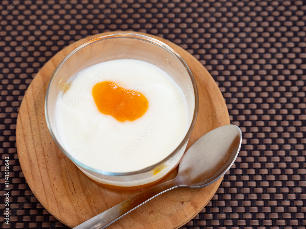 Yogurt with passion fruit marmalade served in glass for dessert Yogurt with passion fruit marmalade served in glass for dessert