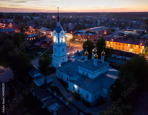 Night aerial view of Russian town of Pokrov with Cathedral of Intercession of Holy Virgin and busy M7 highway photo