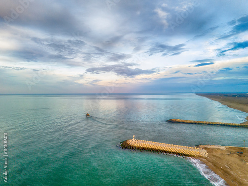 Sunrise Sakarya Karasu beach Aerial view of coastal breakwaters and calm ocean waters. A high-angle, wide shot of a tranquil ocean scene. ADAPAZARI Turkiye Turkey Drone shot  photo