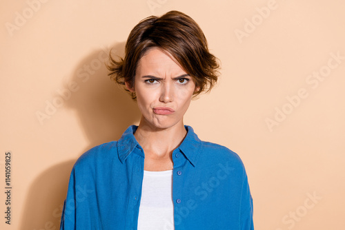 Photo portrait of pretty young girl look angry irritated camera dressed stylish blue outfit isolated on beige color background photo