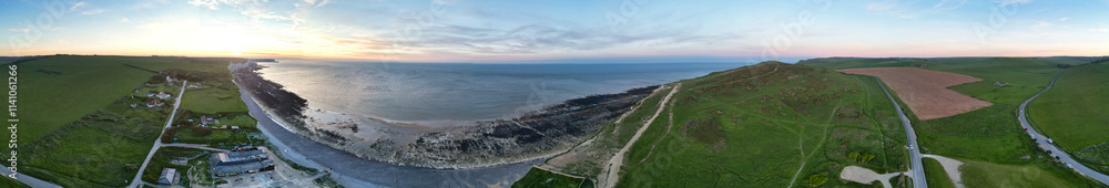 Fototapeta premium Panoramic View of British Landscape and Tourist Attraction of United Kingdom at Beachy Head headland Sea View and Ocean at Eastbourne, East Sussex, England UK During Sunset