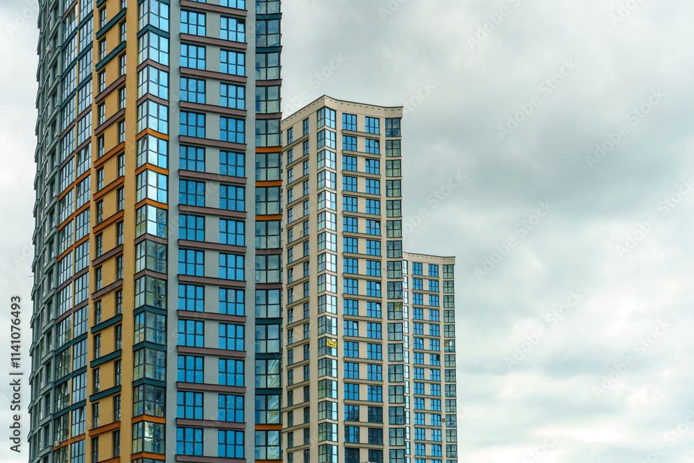 Modern skyscrapers in the new area. Tall buildings made of glass against the sky. Buying or renting luxury real estate. Modern skyscrapers in the new area. Tall buildings made of glass against the sky. Buying or renting luxury real estate.