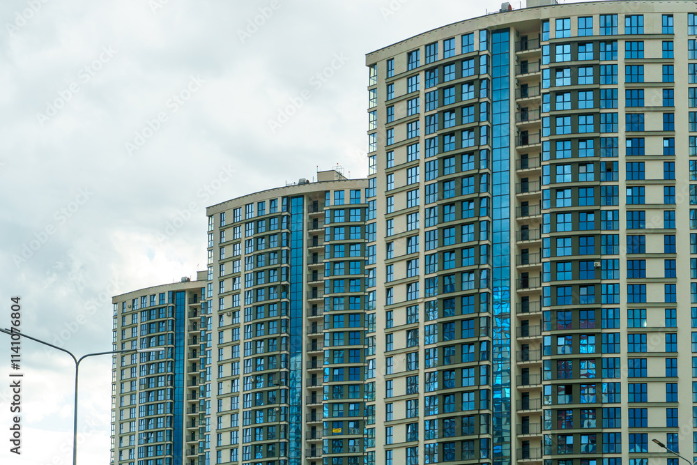 Modern skyscrapers in the new area. Tall buildings made of glass against the sky. Buying or renting luxury real estate. Modern skyscrapers in the new area. Tall buildings made of glass against the sky. Buying or renting luxury real estate.