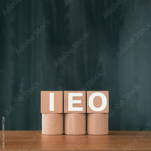 There is wood cube with the word IEO. It is an abbreviation for Initial Exchange Offering as eye-catching image. photo