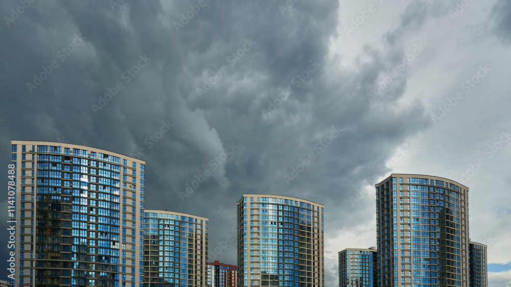 Modern skyscrapers in the new area. Tall buildings made of glass against the sky. Buying or renting luxury real estate. Modern skyscrapers in the new area. Tall buildings made of glass against the sky. Buying or renting luxury real estate.