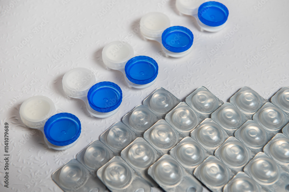 Contact lenses and cases on white background, top view Contact lenses and cases on white background, top view