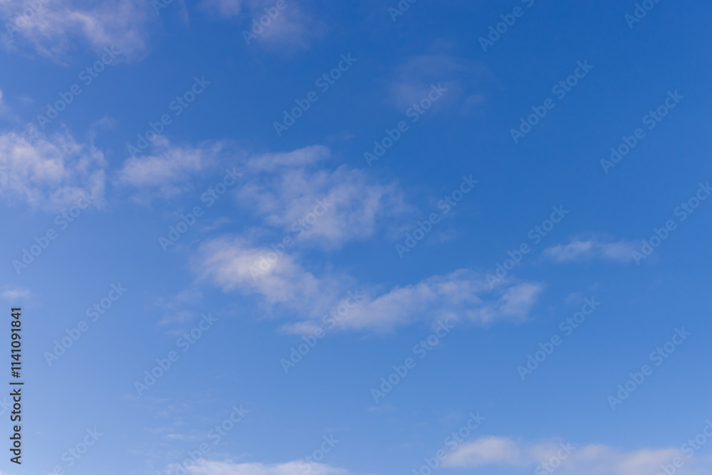 Fototapeta premium Bright Blue Sky with Light Clouds on a Sunny Day