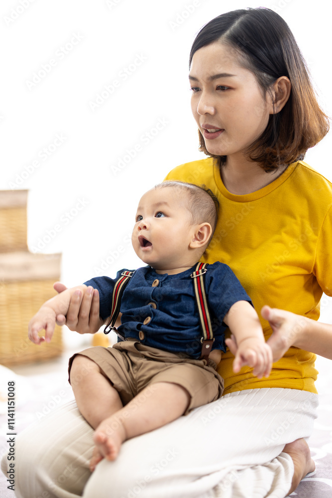 Asian woman with her son holding him by her hand. Happy baby boy was holding by his mother. Asian family with little boy at home enjoy tender family moment, motherhood. Asian woman with her son holding him by her hand. Happy baby boy was holding by his mother. Asian family with little boy at home enjoy tender family moment, motherhood.