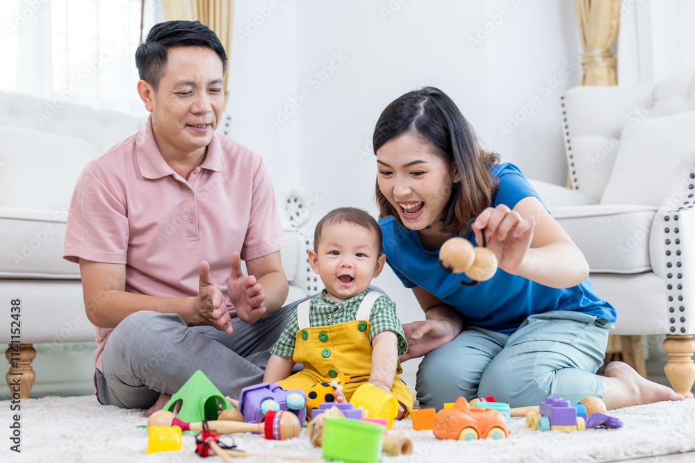 Asian family mother,father ,son playing with colorful kid toys. Happy baby boy in kindergarten or daycare. Child playing with colorful educational toys in preschool. Asian woman. Happy family. Asian family mother,father ,son playing with colorful kid toys. Happy baby boy in kindergarten or daycare. Child playing with colorful educational toys in preschool. Asian woman. Happy family.