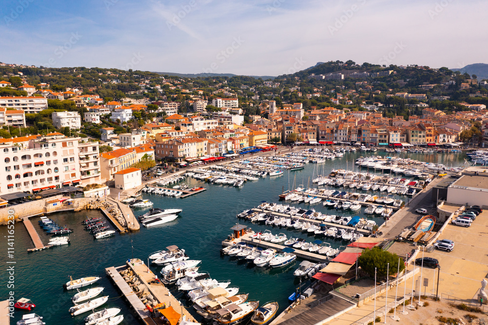 Fototapeta premium Picturesque aerial view of Cassis cityscape on Mediterranean coast with marina on sunny autumn day, Southern France.
