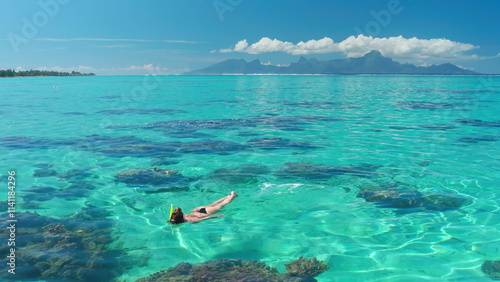 Photography Young woman snorkeling in crystal clear turquoise water enjoying summer vacation