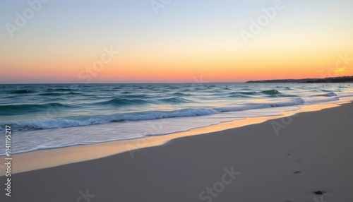 Serene beach scene at sunset with gentle waves and soft sand.