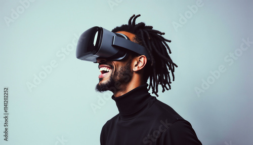 Smiling man wearing a modern virtual reality headset, immersed in a digital experience. The setup suggests personal enjoyment and tech innovation in augmented virtual environments.

