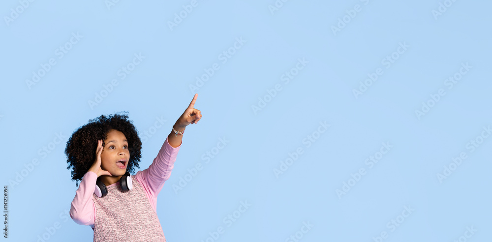 A joyful girl with curly hair points enthusiastically towards the copy space, embodying the fun and curiosity of childhood. Her expression reflects pure happiness in a vibrant setting. A joyful girl with curly hair points enthusiastically towards the copy space, embodying the fun and curiosity of childhood. Her expression reflects pure happiness in a vibrant setting.