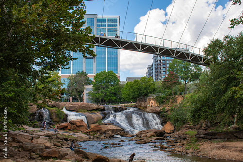 Pedestrian foot bridge in Falls Park on Reedy River at downtown Greenville in South Carolina