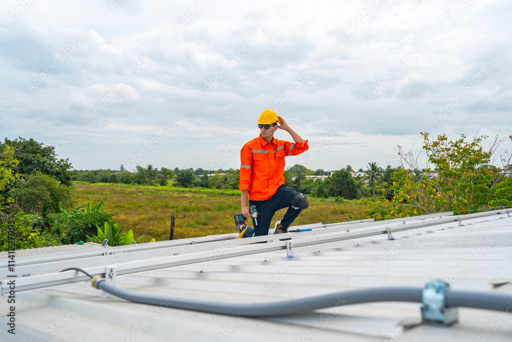 Technician in safety uniform and helmet kneeling on a rooftop, using a drill for precise installation work. A scene highlighting safety, professionalism, and technical expertise in construction. Technician in safety uniform and helmet kneeling on a rooftop, using a drill for precise installation work. A scene highlighting safety, professionalism, and technical expertise in construction.