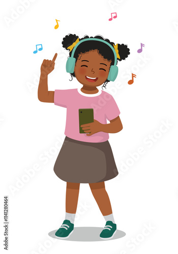 Cute little African boy listen to music with headphone 