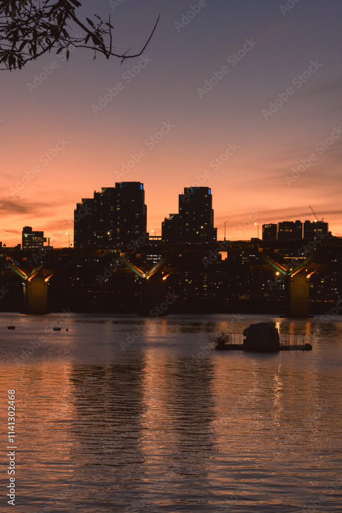 Cityscape at sunset, with a vibrant orange sky Cityscape at sunset, with a vibrant orange sky