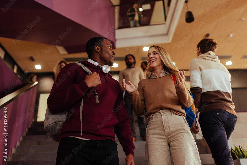 Obraz premium University students walking and talking on stairs