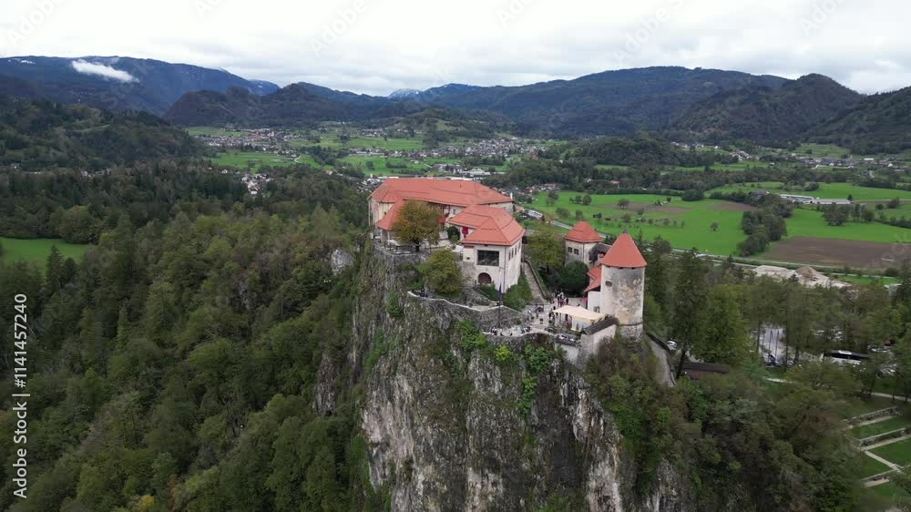 aerial drone shot flying over castle on a cliff above Lake Bled, Slovenia aerial drone shot flying over castle on a cliff above Lake Bled, Slovenia
