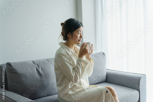 Asian Woman hands holding cup of coffee.